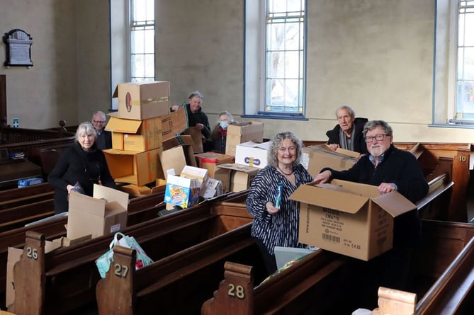 Volunteers in Blaenplwyf sort some of the 150 boxes donated as part of the appeal
