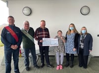 Lodge brothers present cheque to school