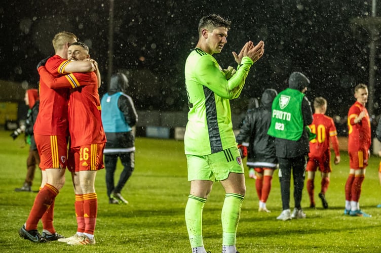 CAERNARFON, WALES - 30 MARCH 2022 - Alex Ramsey applauds the crowd at full time at Cymru C vs England C International Friendly at The Oval, Caernarfon (Pic by Nik Mesney/FAW)