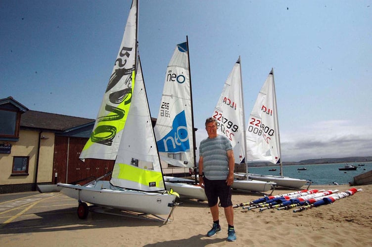 Dovey Yacht Club Sailing Club committee member and project lead Huw Jones-Williams with the four Sport Wales grant funded boats and sail sets 