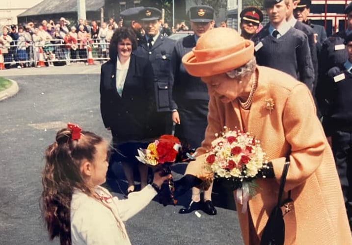 Eleri Williams presents flowers to Queen Elizabeth in Aberystwyth in 1996