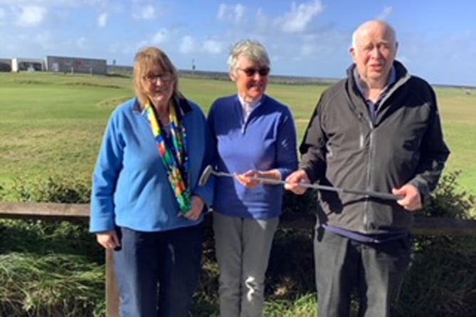 Jean Harrison (in the middle) receiving the John Lewis Putter from Sonja and John, Borth & Ynyslas GC, Nov 2022