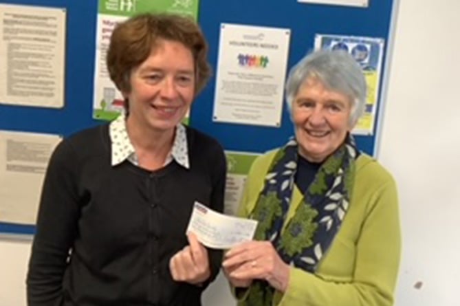 Borth and Ynyslas Golf Club’s Mair Jenkins presenting a cheque to Deborah Pugh, a representative of the Care Society