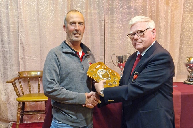 Peter Basnett accepts the Dyfed League 4 Trophy from Steve Brown DGU President 2022