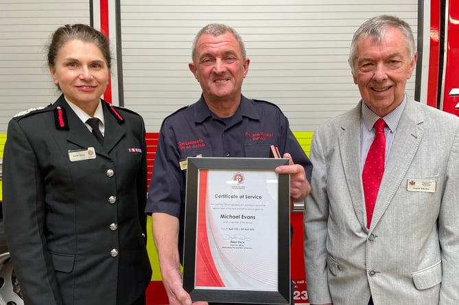 Mike, centre, with chief fire officer Dawn Docx and chair of the fire authority Cllr Dylan Rees