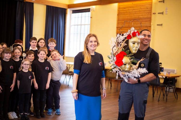 Group leader and founder, Rhian Graham. receives flowers from rapper and rugby player, Lloyd Lewis