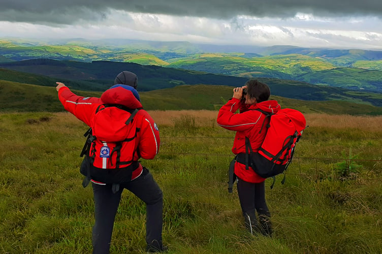 Members of Aberdyfi Search & Rescue Team are pictured searching just below the cloud base