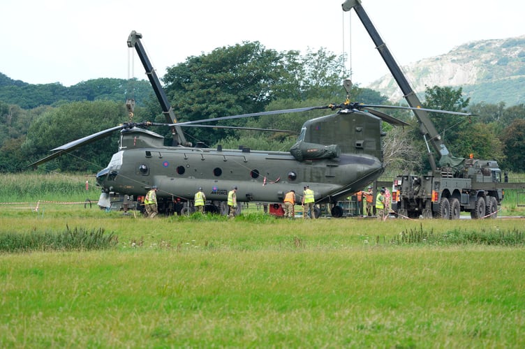 RAF Chinook had a controld  landing in a field in Arthog Gwynedd last Thursday after hydraulic failur on the rear rotors last Week in the dark.
amazing pilot skills to miss all power lines near by.
The Chinook is now bogged in and will need to be repaired before they can get it out 
Today the Chinook Friday 4th August where two crains are in position to lift the Chinook up for matting to be placed under the wheels to be cheaked under the body work 
Picture Erfyl Lloyd Davies Phtogaphy 
