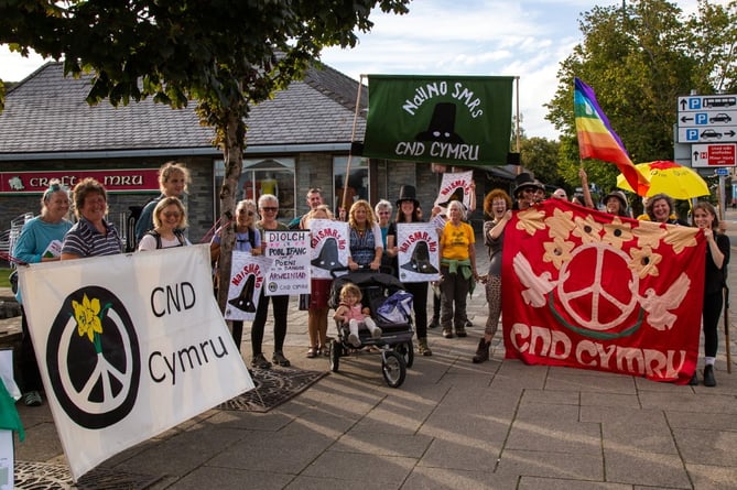 The march from Trawsfynydd to the Eisteddfod in Boduan was organised by the Campaign for Nuclear Disarmament Cymru, with support from anti-nuclear groups CADNO, People Against Wylfa B (PAWB), Nuclear Free Local Authorities (NFLA).