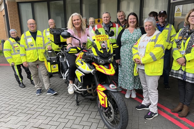 Bronglais Hospital League of Friends Chair Elinor Powell on the new motorbike presented to Blood Bikes Wales Aberystwyth