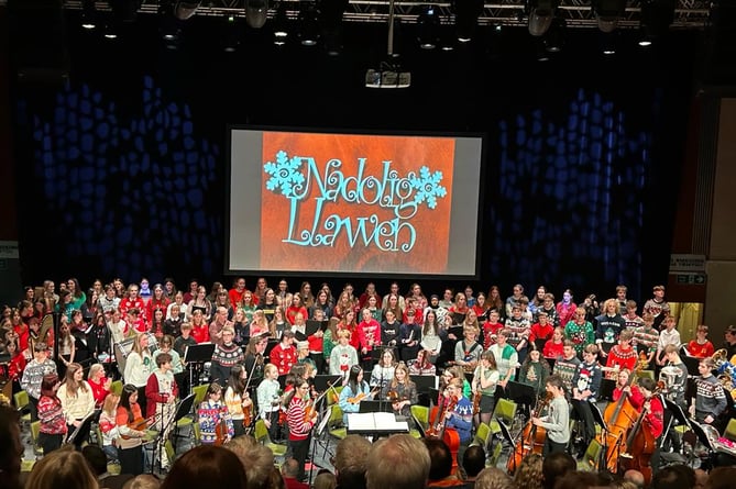 Ceredigion Music Service pupils performing in their Christmas jumpers
