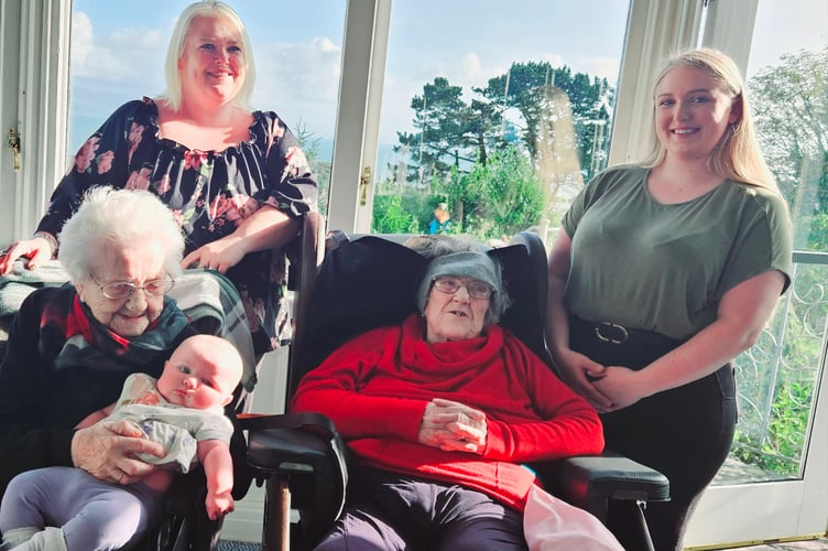 All five generations pose for a family picture at Beti’s birthday, and, below, the picture of their hands