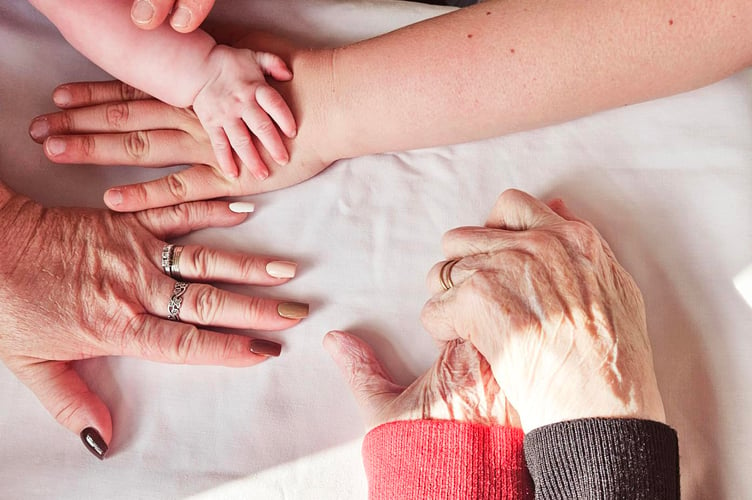 The hands of all five family members