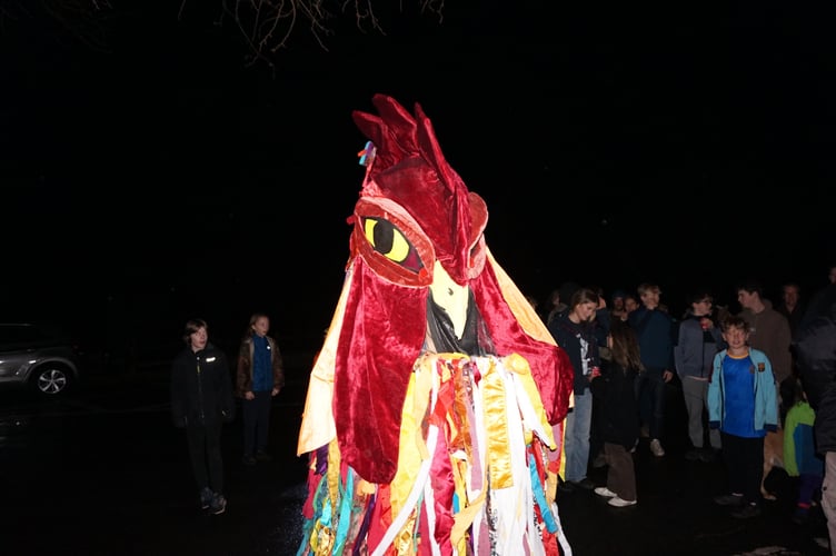 The Ceiliog with the villagers behind him