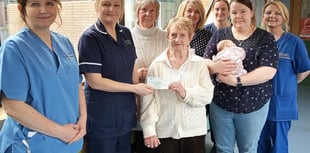 Church present baby unit with cheque to buy cot