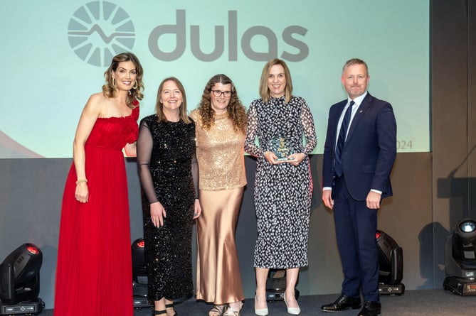 Dulas representatives receive their award from broadcaster Andrea Byrne and Jeremy Miles, Minister for Economy, Energy and Welsh language