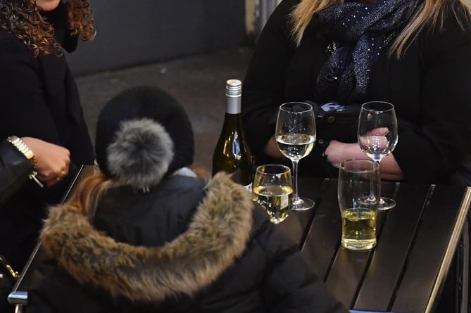 A group of women drinking white wine outside a bar in central London.