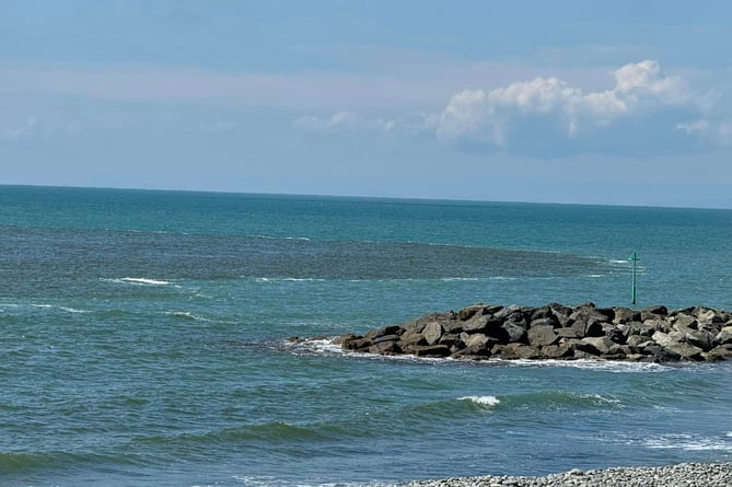 A slick of brown water was spotted seeping into the coastline across Borth on Sunday 16 June