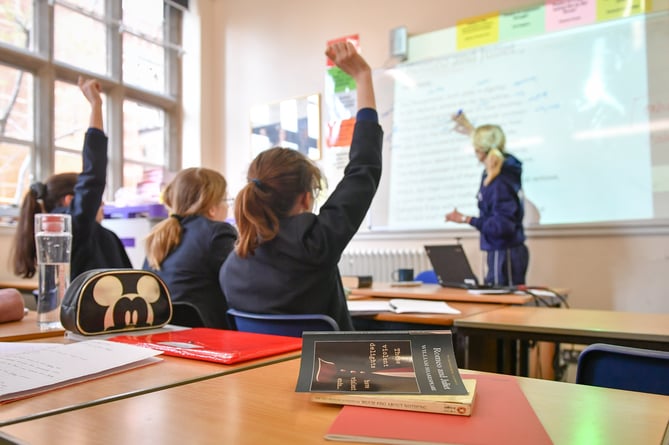 File photo dated 12/09/18 of a teacher and students in a classroom. Poorer pupils are less likely to get into top-performing comprehensive schools than their peers even if there is one in their local area, a study by charity group Sutton Trust has found. Issue date: Thursday January 11, 2024.