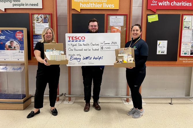 Staff at Tesco Aberystwyth with the cheque to Hywel Dda Health Charities