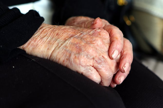 A general view of a close up of the hands of an elderly woman at home.