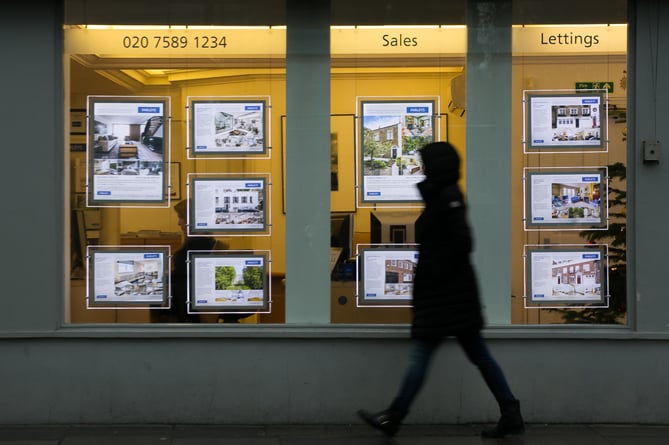 File photo dated 04/12/14 of a pedestrian walking past an estate agents in South Kensington, London. More than half (57%) of first-time buyers clubbed together with someone else to buy a home last year, with 43% purchasing their property on their own, according to data from TSB. Issue date: Thursday March 14, 2024.