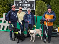 Llŷn guide dog owners hike up mountain to raise thousands for charity