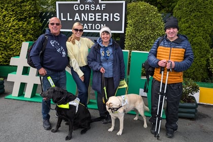 Llŷn guide dog owners hike up mountain to raise thousands for charity