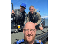 Gwynedd PCSO poses with screen stars Bradley Cooper and Bear Grylls