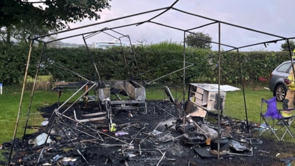 Fire destroys trailer tent but five people and dog survive