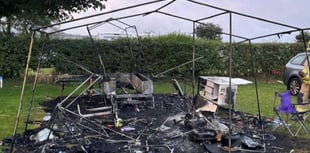 Fire destroys trailer tent but five people and dog survive