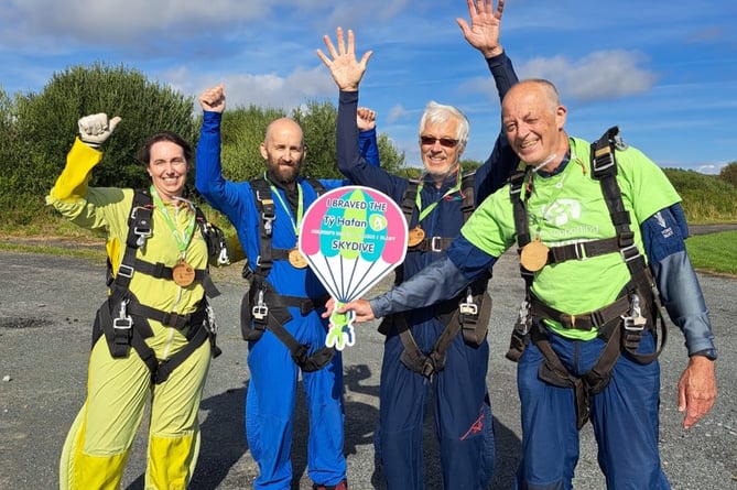 Philip, right, wearing a Ty Hafan t-shirt, his brother, John, next to him, and others who completed the parachute jump that day