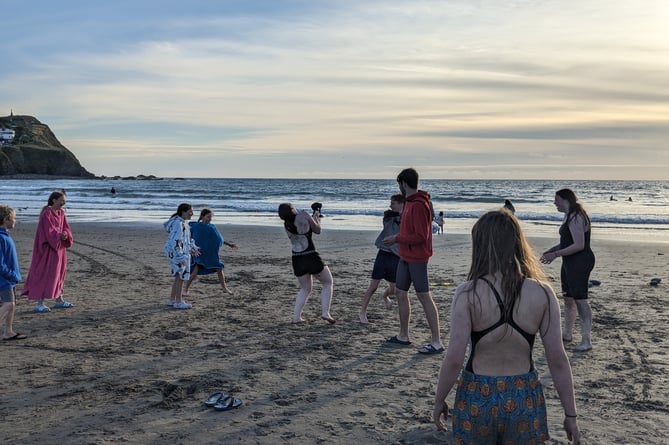 After hours in the sea, the swimmers turn their attention to beach volleyball