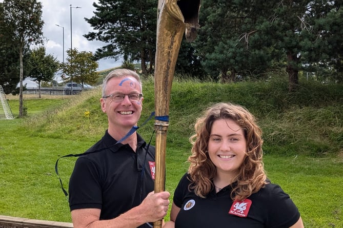 Beca Davies and Toby Driver with the Carnyx war horn. Photo: Crown Copyright: RCAHMW