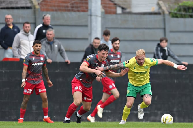 CAERNARFON, GWYNEDD, WALES - 26th AUGUST 2024 - Caernarfon's Marc Williams is pressured by Bala's Ross White during Caernarfon Town vs Bala Town in Round 4 of the JD Cymru Premier at The Oval, Caernarfon (Pic by Sam Eaden/FAW)