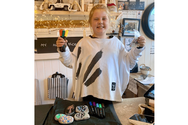 Lottie, 8, has been painting pebbles at Parsley & Thyme in Aberaeron to raise money for Guide Dogs