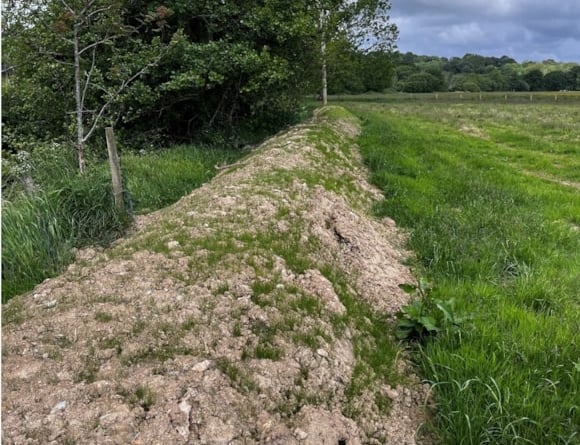 The earth bund before remediation work took place. Photo: Natural Resources Wales