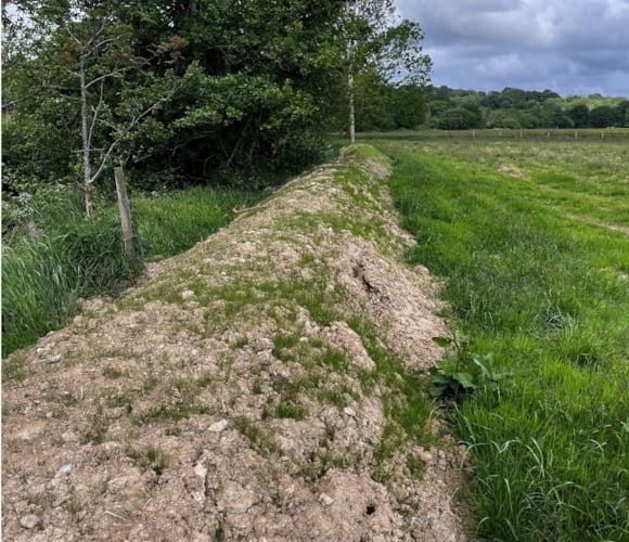 The earth bund before remediation work took place. Photo: Natural Resources Wales