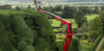 Gardener uses cherry picker to trim castle's 300-year-old hedges