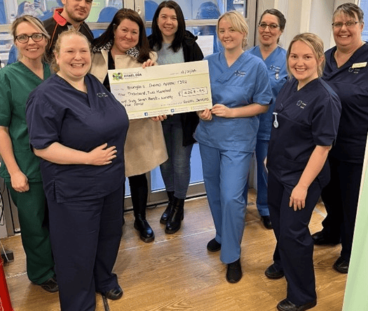 Owain Jenkins, Lisa Hurcombe and Hayley Jenkins with staff from the Chemotherapy Day Unit