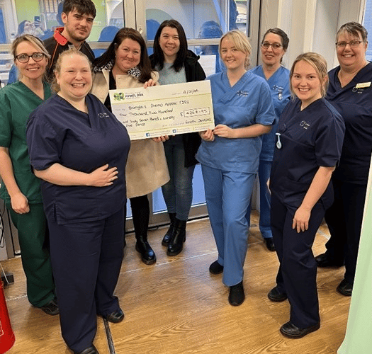 Owain Jenkins, Lisa Hurcombe and Hayley Jenkins with staff from the Chemotherapy Day Unit