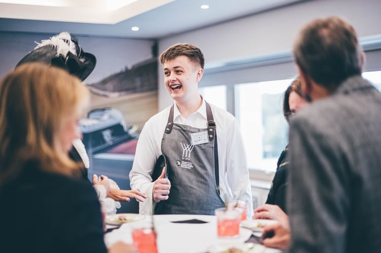 Former Coleg Meirion-Dwyfor student Jack Williams talking to guests while competing at the Young Waiter 2024 Welsh final. Photo: Aled Llywelyn