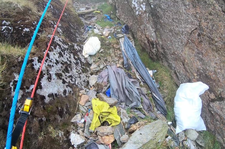 Video grab from heartbreaking footage showing 'waterfalls' of 3,000 bits of rubbish including drinks cans and Santa hats left by people on Mount Snowdon.The cascades of waste on Yr Wyddfa Mountain in Wales including drinks bottles requires urgent action volunteers warn. Photo released October 16 2024. An 'unprecedented' litter-pick on the iconic mountain left volunteers in shock - as they realised they had only scratched the surface.From a misplaced Santa hat to plastic bottles and rucksack covers - The British Mountaineering Council volunteers removed 2,765 items of litter from Yr Wyddfa during a two-day-clean up.
