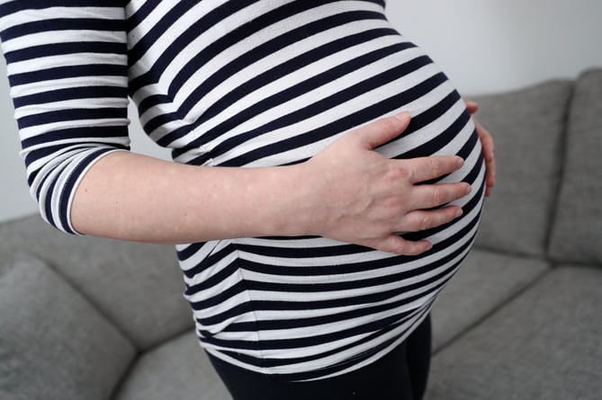 Undated file photo of a pregnant woman holding her stomach. Most new mothers suffer financial stress during pregnancy and maternity leave, forcing them back to work earlier than they would like after the birth, research suggests. Maternity Action said its survey of 1,000 new mothers showed that three out of five managed by using credit cards, and a similar number had returned to work early or were planning to do so. Issue date: Wednesday May 8, 2024.