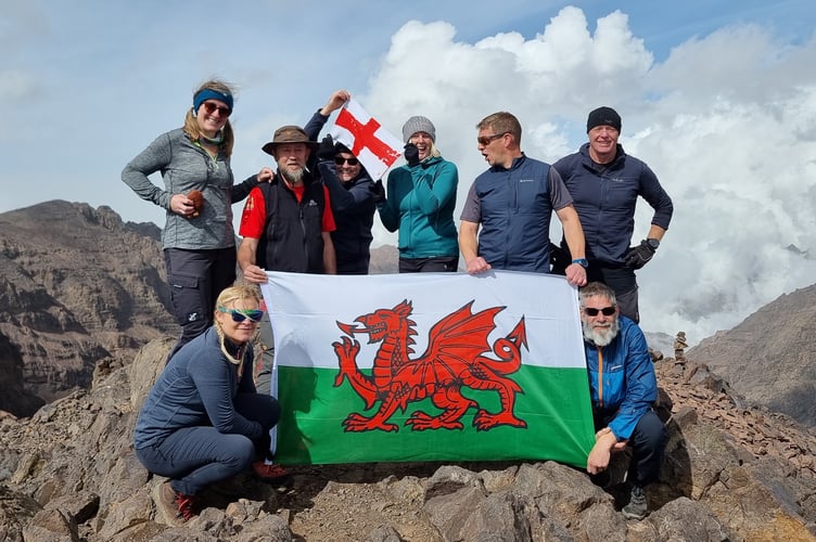 Mike Hirst and friends at the summit of a mountain during the challenge