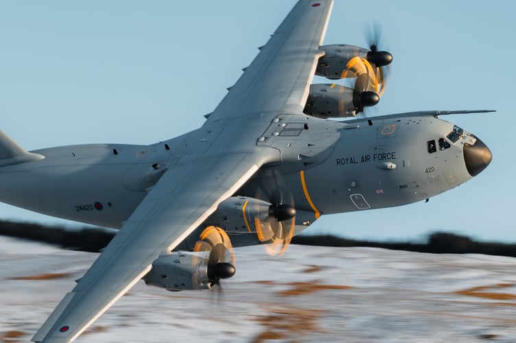 A400M transport aircraft flies through Mach Loop in Eryri National Park (Snowdonia) on November 21, 2024.    Jaw-dropping pictures show RAF airplanes zooming through a snowy Mach Loop in Wales on Thursday (21 Nov). An RAF Hawk T2 advanced trainer aircraft and an A400M transport aircraft were caught on camera by Sgt 'Matty' Matthews. The 84iton A400M had already completed an airdrop over Salisbury Plains, flown over Scotland and the Lake District before passing through the Mach Loop and heading home to RAF Brize Norton in Oxfordshire. "Come rain or snow, RAF aircraft and their crews continue to operate whatever the weather," said the RAF, "In this case, with the snowy backdrop of the Eryri National Park behind them."
