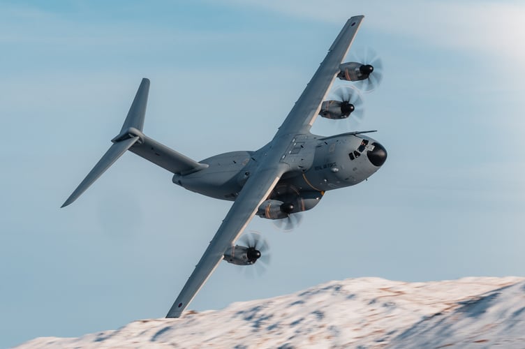 A400M transport aircraft flies through Mach Loop in Eryri National Park (Snowdonia) on November 21, 2024.    Jaw-dropping pictures show RAF airplanes zooming through a snowy Mach Loop in Wales on Thursday (21 Nov). An RAF Hawk T2 advanced trainer aircraft and an A400M transport aircraft were caught on camera by Sgt 'Matty' Matthews. The 84iton A400M had already completed an airdrop over Salisbury Plains, flown over Scotland and the Lake District before passing through the Mach Loop and heading home to RAF Brize Norton in Oxfordshire. "Come rain or snow, RAF aircraft and their crews continue to operate whatever the weather," said the RAF, "In this case, with the snowy backdrop of the Eryri National Park behind them."
