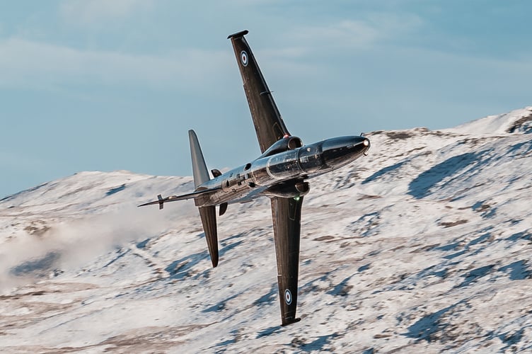 Hawk T2 advanced trainer aircraft flies through Mach Loop in Eryri National Park (Snowdonia) on November 21, 2024.    Jaw-dropping pictures show RAF airplanes zooming through a snowy Mach Loop in Wales on Thursday (21 Nov). An RAF Hawk T2 advanced trainer aircraft and an A400M transport aircraft were caught on camera by Sgt 'Matty' Matthews. The 84-ton A400M had already completed an airdrop over Salisbury Plains, flown over Scotland and the Lake District before passing through the Mach Loop and heading home to RAF Brize Norton in Oxfordshire. "Come rain or snow, RAF aircraft and their crews continue to operate whatever the weather," said the RAF, "In this case, with the snowy backdrop of the Eryri National Park behind them."
