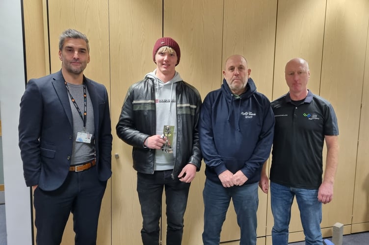 Harry Sutherland and his trophy after winning the plastering competition at SkillBuild2024, with (from left) Coleg Menai Assistant Principal Mark Allen, construction instructor Steven Ellis and lecturer Wayne Taylor