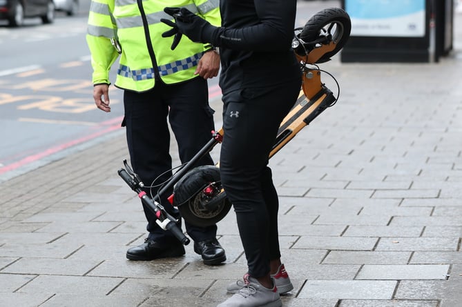 An e-scooter rider is stopped by a police officer in Islington, London, during an operation to educate them as to the risks associated with the use of e-scooters, which are currently illegal to use on the public highways including pavements.